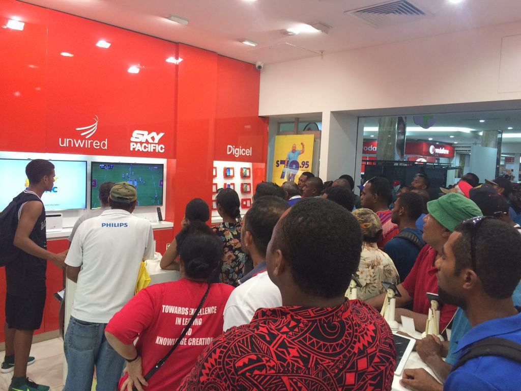 Watching rugby at the cell phone store in Fiji